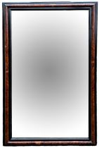 AN AMBOYNA AND EBONISED FRAMED MIRROR. (134cm x 80cm) Condition: good overall, some light marks