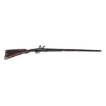 AN EARLY 19TH CENTURY FLINTLOCK SPORTING RIFLE The finely carved walnut stock with silver inlays and