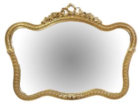 A LATE 20TH CENTURY CARTOUCHE SHAPED ORNAMENTAL GILDED OVERMANTEL MIRROR Moulded with flowering