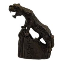 A BRONZE MEIJI STYLE TIGER Standing on rock impressed with Japanese characters. (5cm x 5cm)