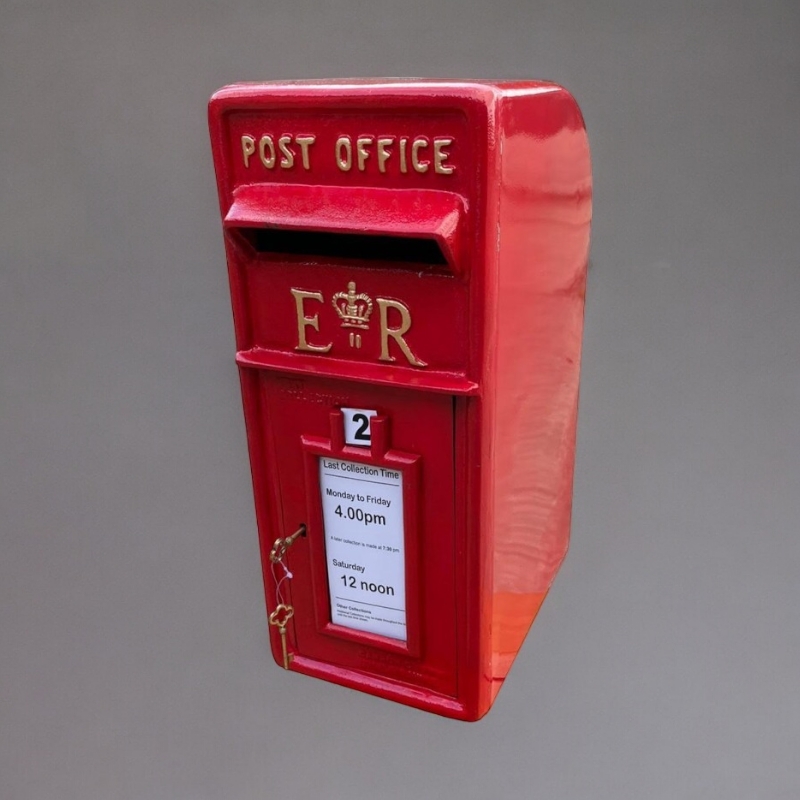 A 20TH CENTURY STYLE CAST IRON RED POST BOX With embossed Elizabeth II insignia. (23cm x 34cm x