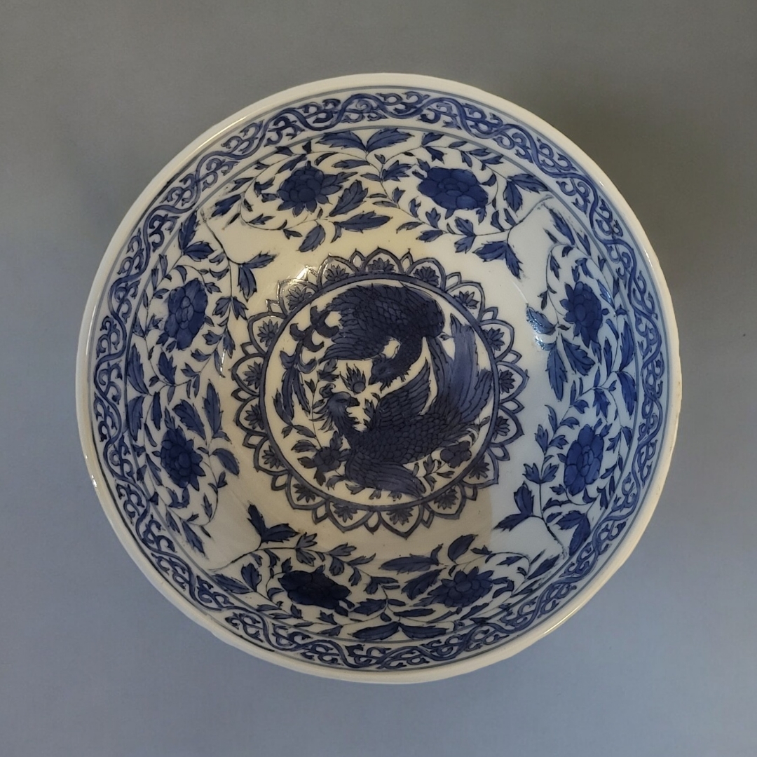 A 19TH CENTURY CHINESE STYLE BLUE AND WHITE FOOTED BOWL With entwined phoenix and lotus