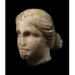 A FRAGMENTARY MARBLE HEAD OF A GODDESS. Probably Greek, circa 1st – 2nd century AD