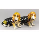 A PAIR OF MID-20TH CENTURY LIFE-SIZE GLAZED CERAMIC BASSET HOUND DOG SCULPTURES. (h 41cm x w 63cm