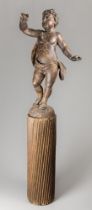 A 17TH/18TH CENTURY CARVED WOOD PUTTI UPON A FLUTED COLUMN. (h 161cm)