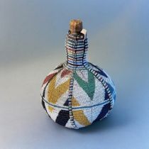 A 20TH CENTURY AFRICAN BEADED GOURD BOTTLE Having a colourful arrangement of glass beads with