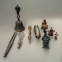 A COLLECTION IF TIBETAN BRONZE AND BRASS BUDDHIST CEREMONIAL ITEMS Comprising a ritual bell,