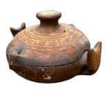 A SOUTH AMERICAN TERRACOTTA POTTERY COOKING POT AND COVER Twin animal mask handles and painted