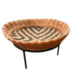 A SOUTH AMERICAN BANIVA GUAINIA RIVER STRAW BOWL ON STAND Geometric pattern on metal stand. (