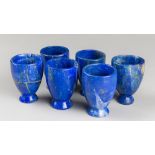 A SET OF SIX LAPIS LAZULI EGG STANDS. Each (h 6cm x w 4.5cm x d 4.5cm)