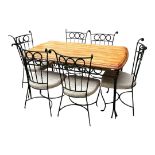 A PINE AND WROUGHT IRON DINING TABLE Complete with six matching chairs. Condition: good overall,