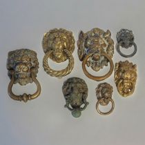 A COLLECTION OF VINTAGE BRASS LION MASK DOOR KNOCKERS To include a mask with rope twist knocker. (