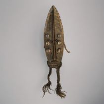 AN AFRICAN CARVED WOODEN GREBO 'LEAF FORM' MASK Having painted decoration and rope twists to