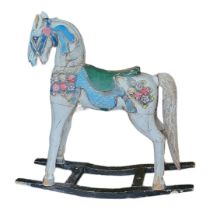 A CARVED WOODEN CHILD'S ROCKING HORSE In cream painted finish with floral decoration. (124cm x
