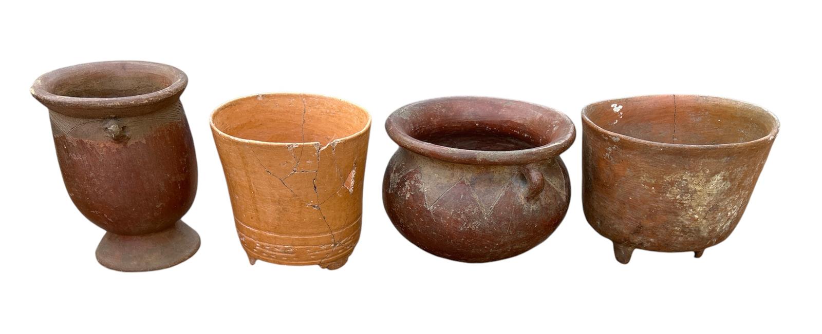 A COLLECTION OF FOUR SOUTH AMERICAN POTTERY BOWLS Two with handles and two with tripod legs. (