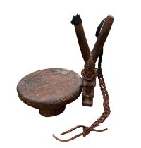 A CARVED WOODEN FIGURAL CATAPULT, FEMALE FORM WITH LEATHER STRAP Together with a carved wooden