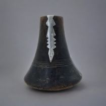 AN AFRICAN CARVED WOODEN RWANDA TUTSI MILK JUG Conical form with applied metallic mound and dome