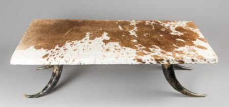 A MID-20TH CENTURY CATTLE HIDE AND HORN COFFEE TABLE. (h 28cm x w 95cm x d 49cm)