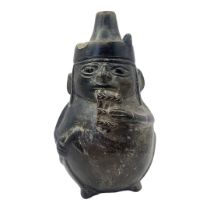 A SOUTH AMERICAN POTTERY FIGURAL JUG Cylindrical finial and playing pan pipes. (approx 18cm)