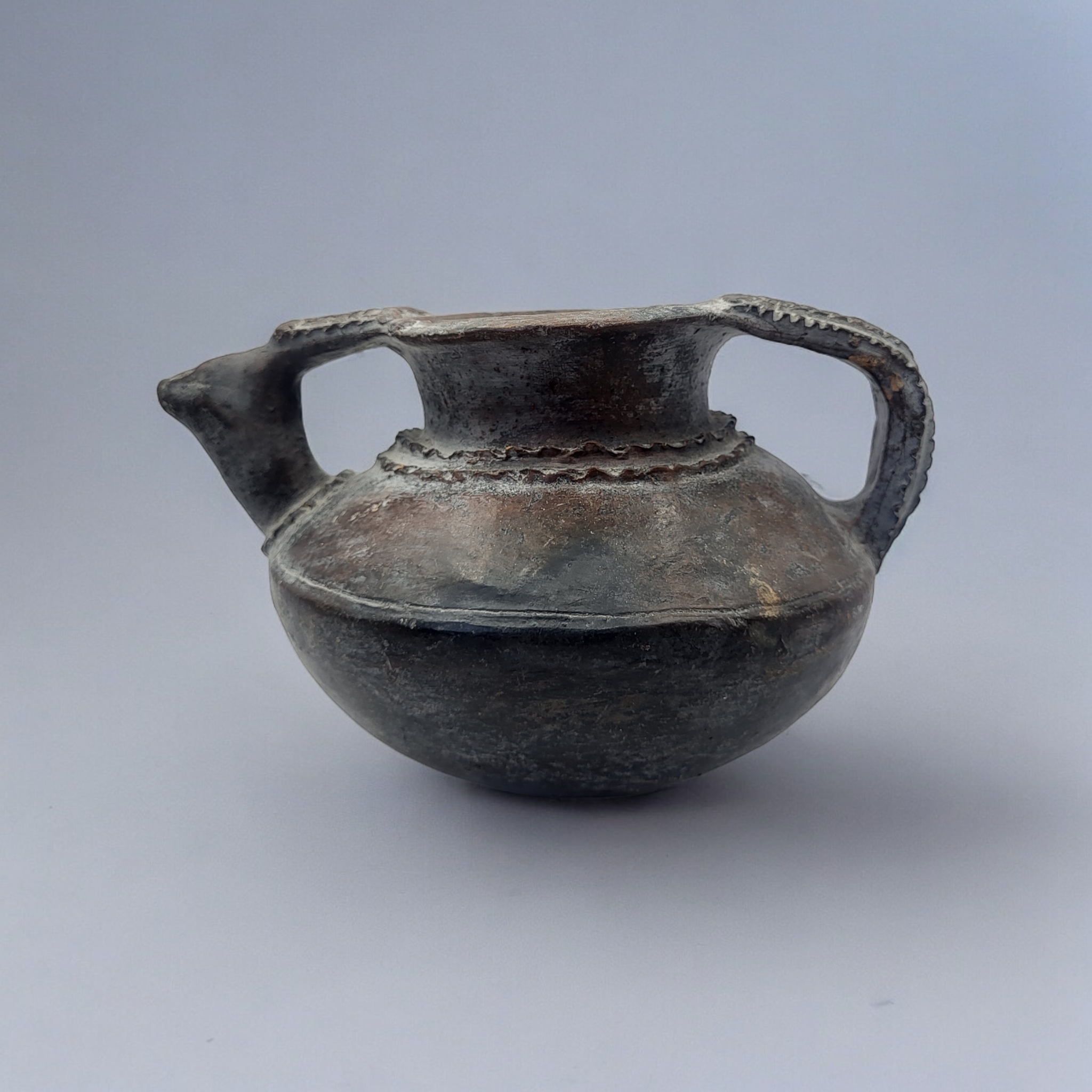 AN AFRICAN TERRACOTTA POTTERY WATER JUG Having a single handle with moulded decoration. (approx