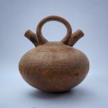 A SOUTH AMERICAN TERRACOTTA POTTERY DOUBLE SPOUT VASE Single handle with two spouts and incised