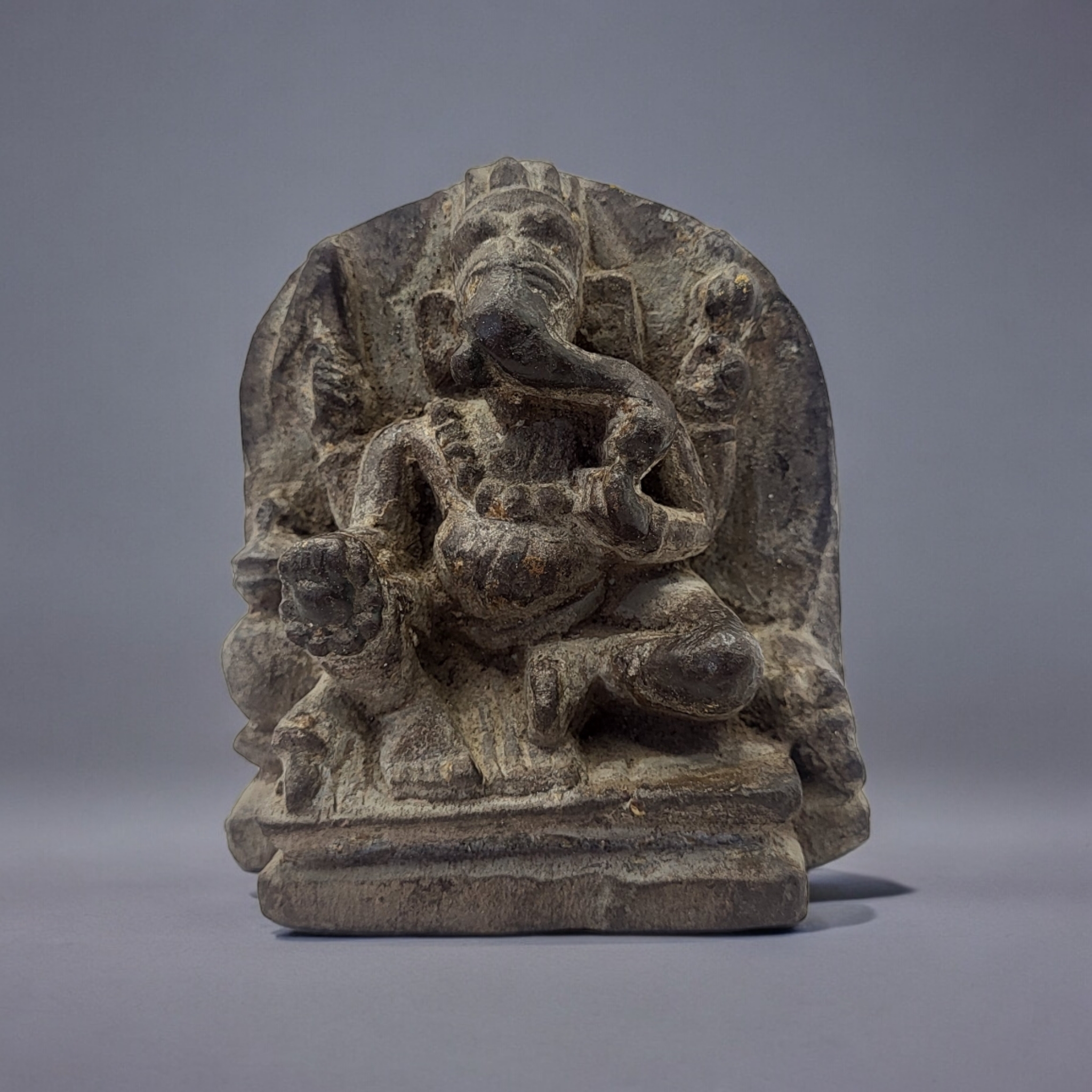 AN AN INDIAN BUDDHIST CARVED STONE GANESH FIGURE Seated pose with flatback. (approx 9cm x 10cm)