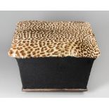 A REGENCY OTTOMAN WITH LEOPARD SKIN COVERED SEAT. (h 50cm x w 66cm x d 48cm)