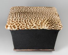 A REGENCY OTTOMAN WITH LEOPARD SKIN COVERED SEAT. (h 50cm x w 66cm x d 48cm)