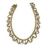 AN EARLY 20TH CENTURY INDIAN YELLOW METAL NECKLACE Pierced links with swags. (approx 50cm)