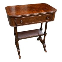 A REGENCY STYLE BURR WALNUT SIDE TABLE The single drawer above book trough, with turned columns