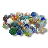 A MIXED COLLECTION OF FIFTY-TWO GLASS MARBLES Consisting of some Victorian Nailsea glass marble