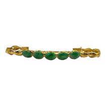 A VINTAGE CHINESE YELLOW METAL AND JADE BRACELET Five cabochon cut stones with scrolled yellow metal