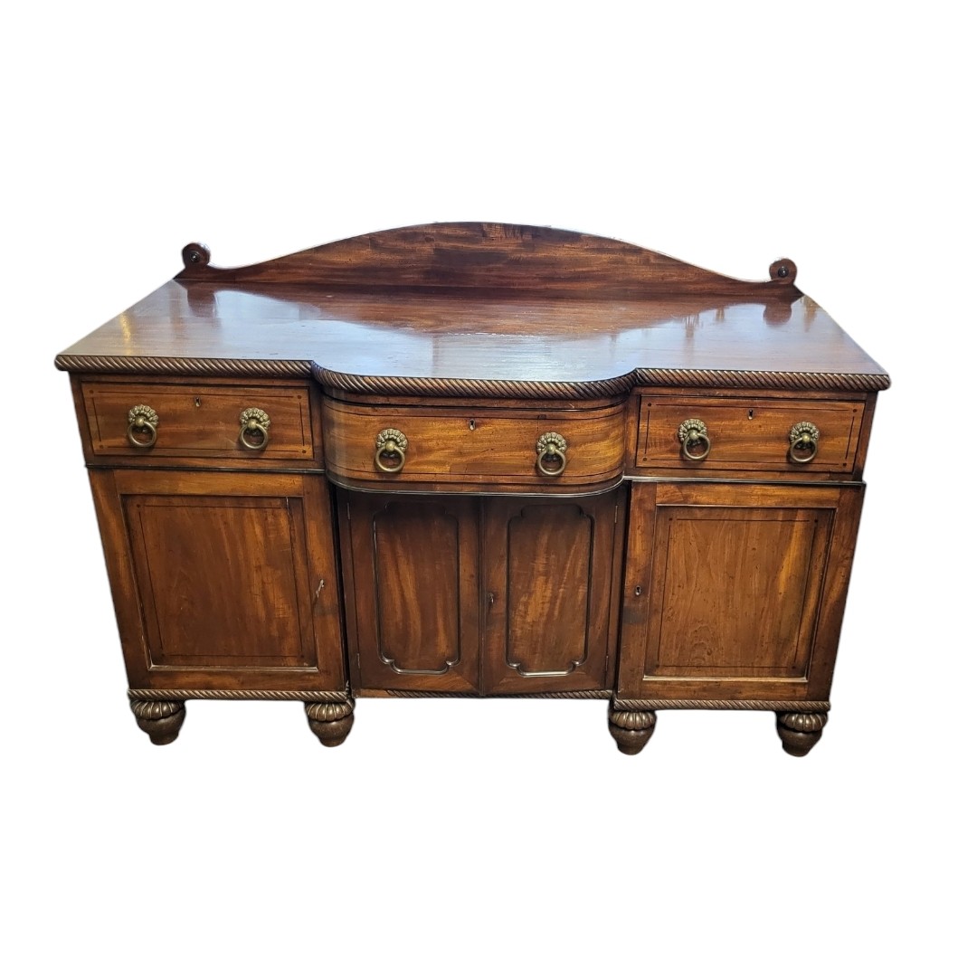 A REGENCY PERIOD MAHOGANY SIDE CABINET AND EBONY LINE INLAY With three drawers above cupboards, on