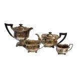 AN EARLY 20TH CENTURY SILVER FOUR PIECE TEA SET Including a teapot, hot water jug, sugar bowl and