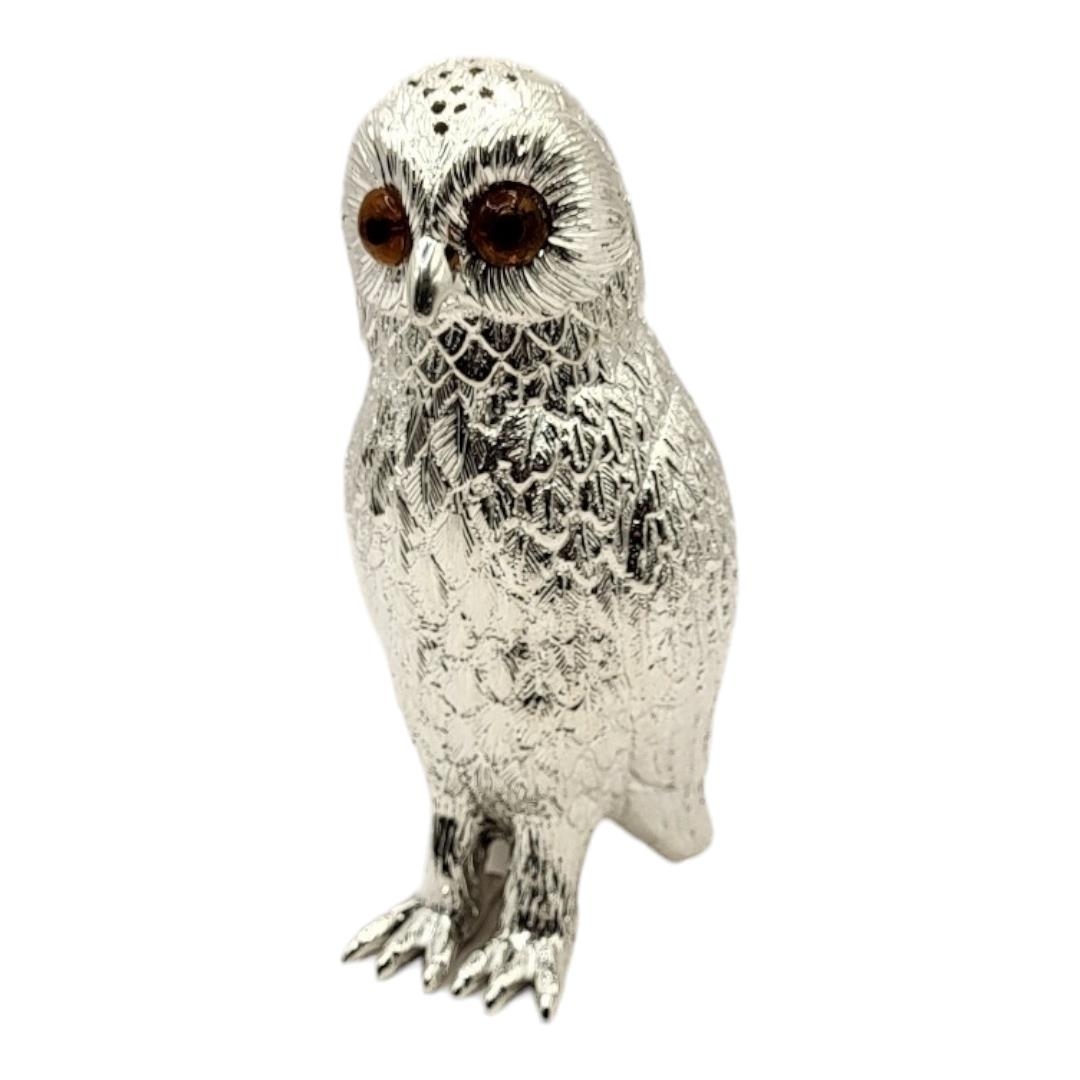 A SILVER PLATED OWL SUGAR SIFTER With amber glass eyes. (7cm x 15.5cm) Condition: good