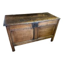 A 17TH/18TH CENTURY OAK PLAIN PANELLED COFFER With iron nail hinges, on stile legs. (128cm x 57cm