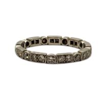 A VINTAGE WHITE METAL AND DIAMOND FULL ETERNITY RING Having an arrangement of round cut diamonds.