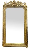 A VICTORIAN STYLE GILT FRAMED MIRROR With floral crest and putti above a bevelled plate. (82cm x