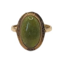A VINTAGE 9CT GOLD AND JADE RING Cabochon cut stone in a collet mount. (size L) Condition: good