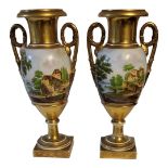 A PAIR OF EARLY 19TH CENTURY CONTINENTAL PORCELAIN CAMPANA SHAPED TWIN HANDLED PEDESTAL VASES