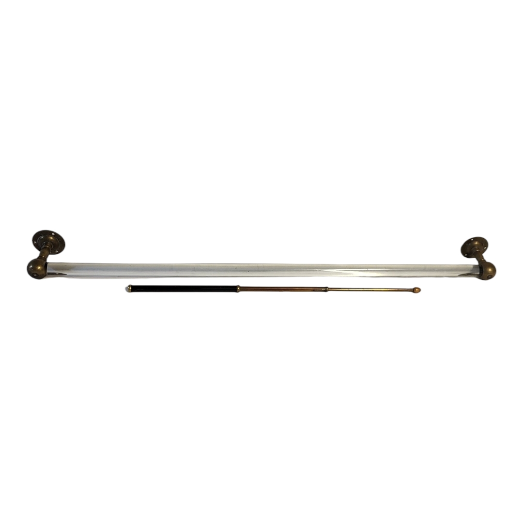 A VICTORIAN BRASS AND GLASS TOWEL RAIL Clear glass central rod and brass mounts, together with an