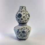A 19TH CENTURY CHINESE STYLE BLUE AND WHITE DOUBLE GOURD VASE With lotus and vine decoration. (