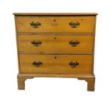 A GEORGIAN PINE CHEST OF THREE LONG DRAWERS Fitted with brass handles, on bracket feet. (78cm x 43cm