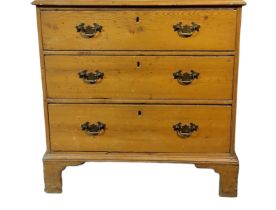A GEORGIAN PINE CHEST OF THREE LONG DRAWERS Fitted with brass handles, on bracket feet. (78cm x 43cm