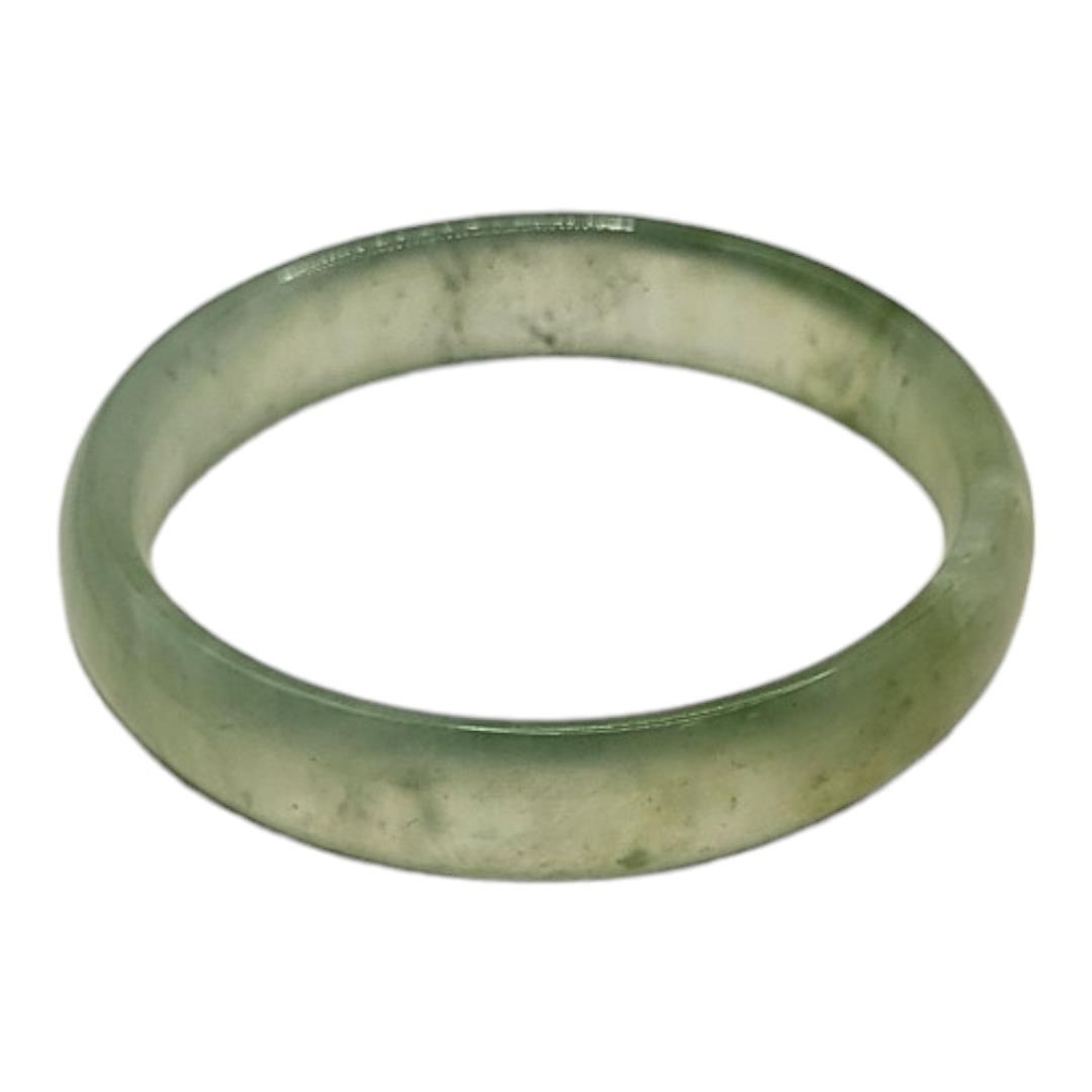 A PALE GREEN CELADON JADE BANGLE. (inside diameter 6cm) Condition: good overall - Image 2 of 2