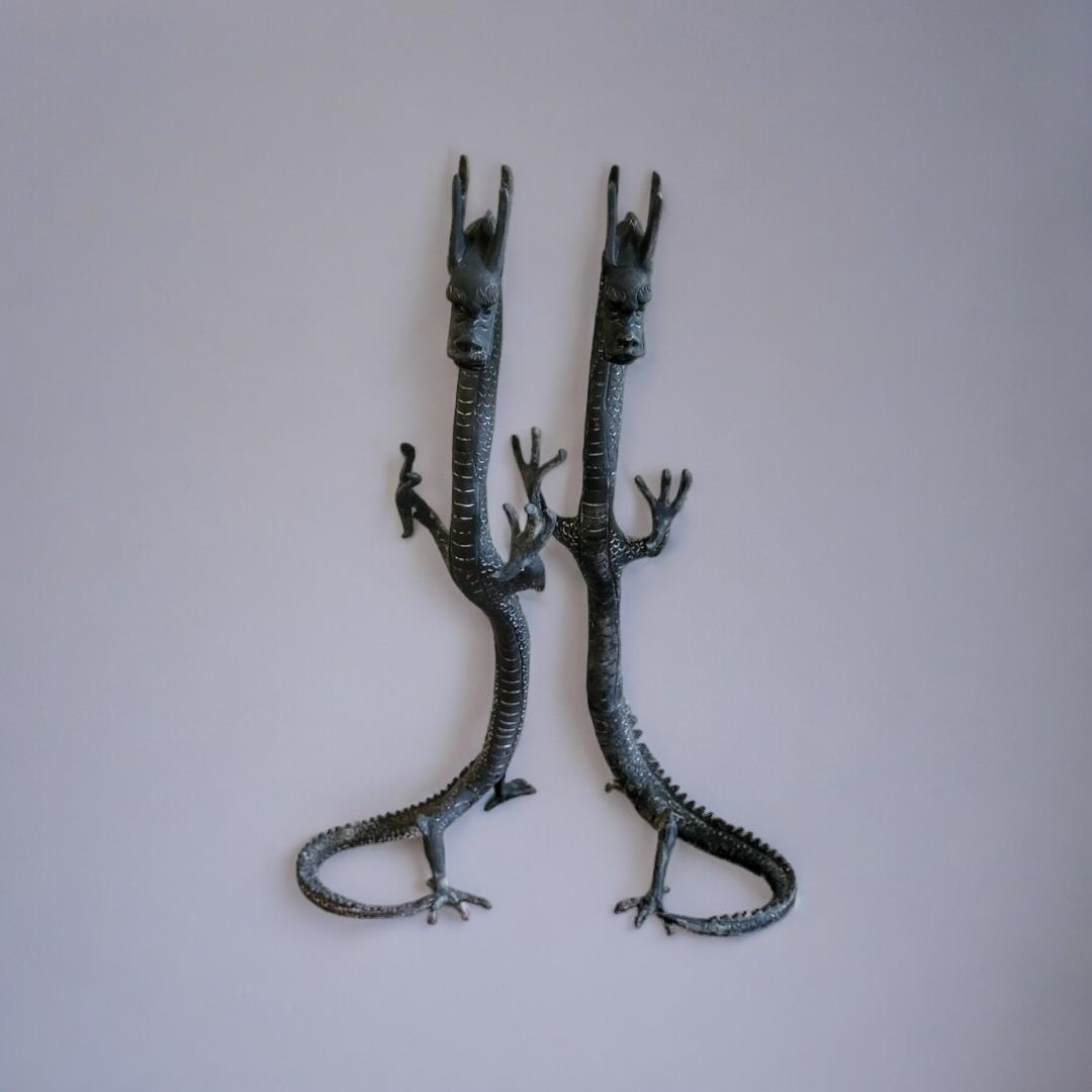 A PAIR OF ORIENTAL STYLE BRONZE STANDING DRAGONS With the curled tail as support. (19cm x 20cm x