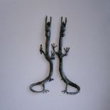 A PAIR OF ORIENTAL STYLE BRONZE STANDING DRAGONS With the curled tail as support. (19cm x 20cm x