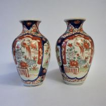 A PAIR OF 18TH CENTURY JAPANESE IMARI STYLE VASES Taking baluster form with painted floral