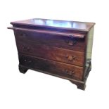 A GEORGIAN SOLID MAHOGANY CHEST With brushing slide above three long drawers fitted with brass