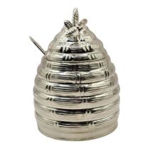 A SILVER PLATED HONEY POT Taking the form of a hive with bee decorations to lid, glass insert and